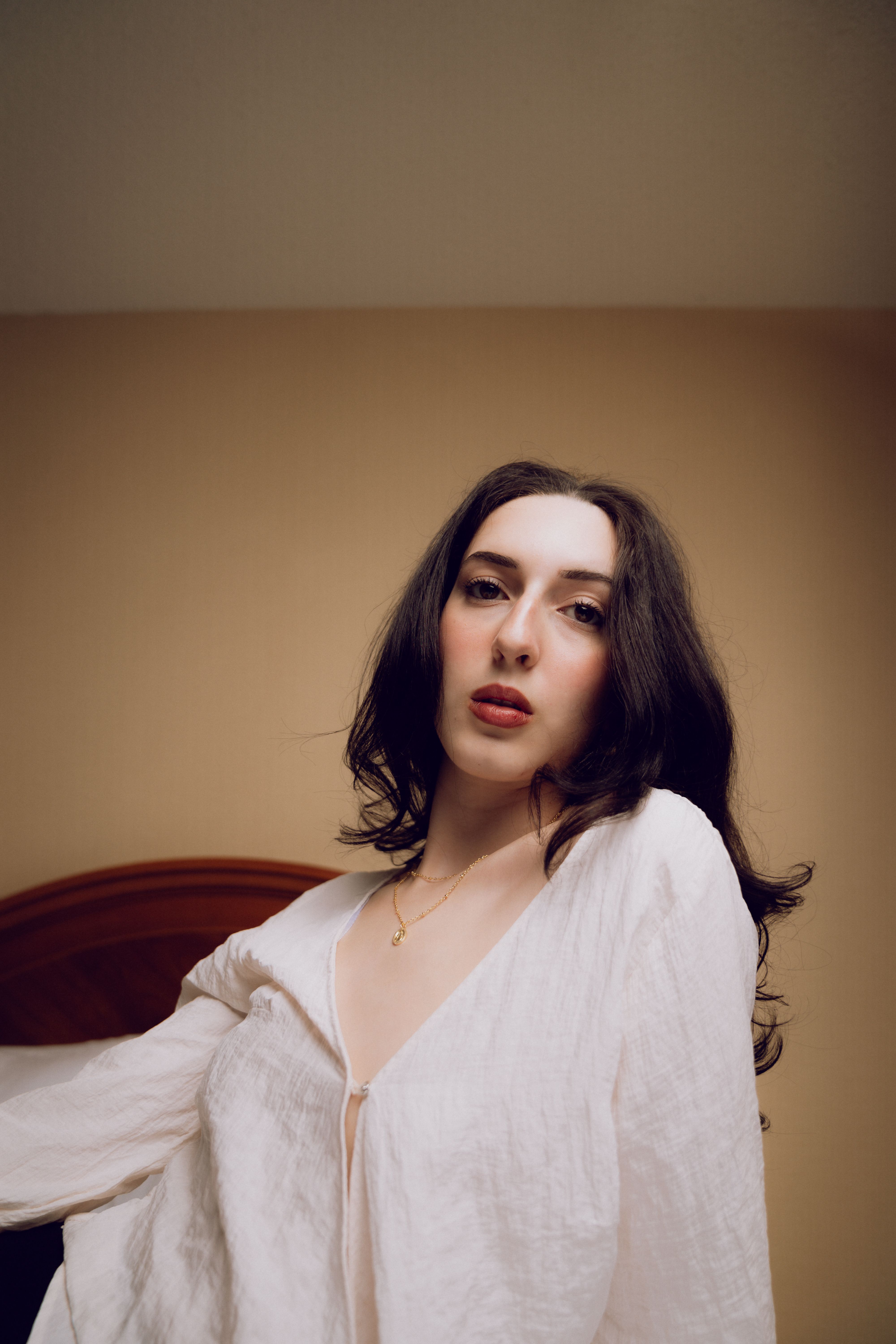 A woman in a white shirt posing for a portrait · Free Stock Photo