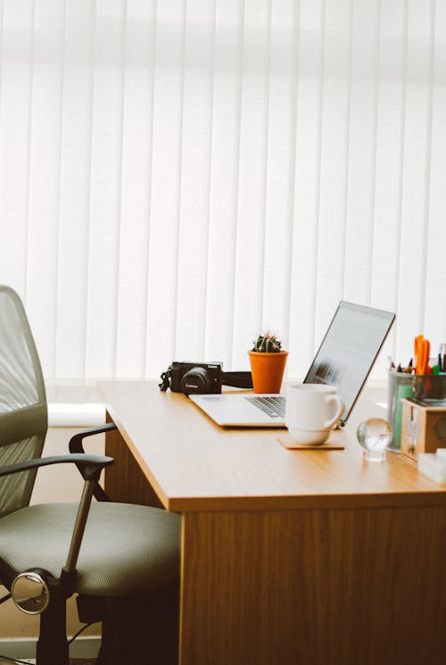 Free Laptop Computer Beside Mug On Desk Stock Photo