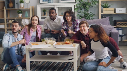 A group of people sitting on a couch playing video games