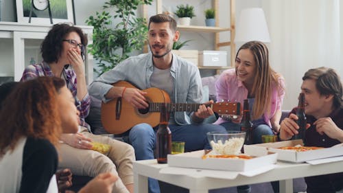 Group of friends having fun in a living room