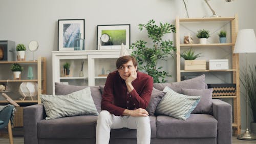 A man sitting on a couch in a living room