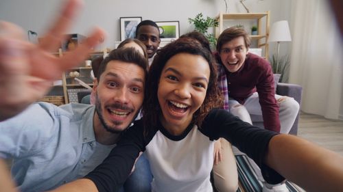 Free Happy friends taking a cheerful group selfie indoors, radiating joy and togetherness. Stock Photo