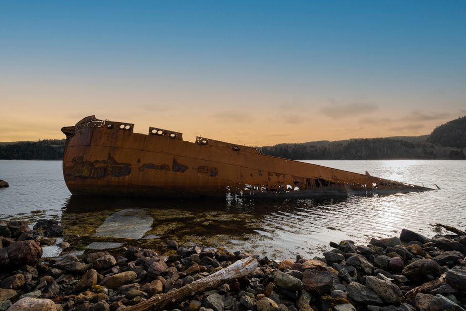 A mesmerizing shipwreck at sunset in Conception Harbour, Newfoundland, Canada.