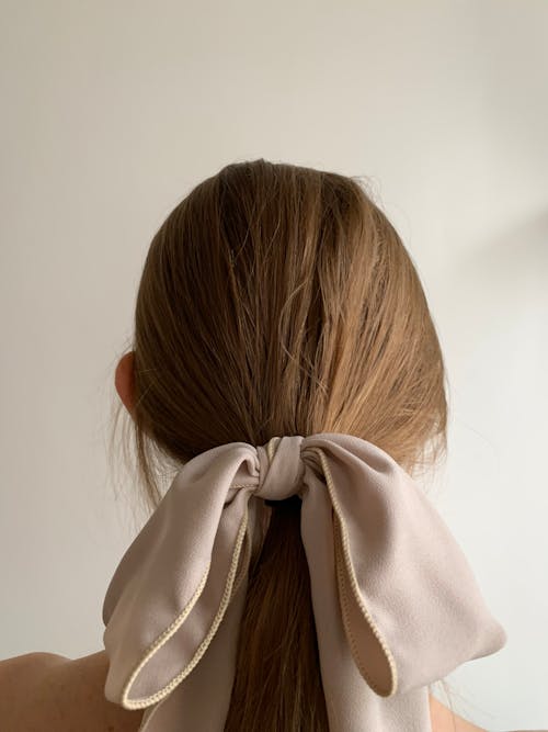 A woman with a bow tied to her hair