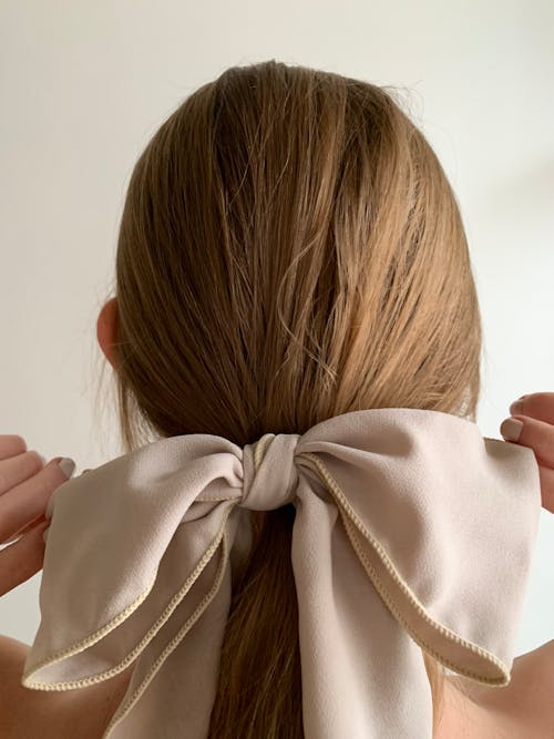 A woman with her hair tied up in a bow