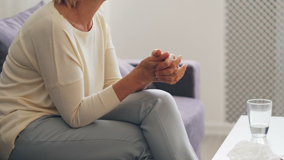 elder care agencies near me - An elderly woman seated thoughtfully in an indoor counseling setting.