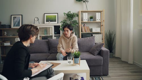 Two people sitting on a couch in a living room