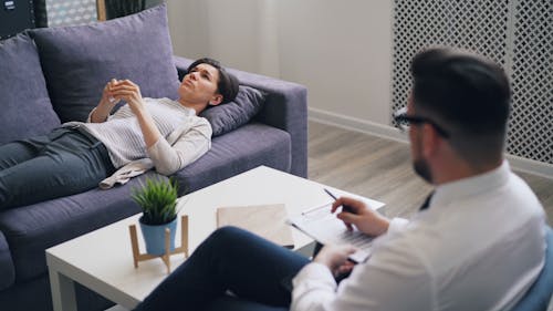 A man and woman are sitting on a couch