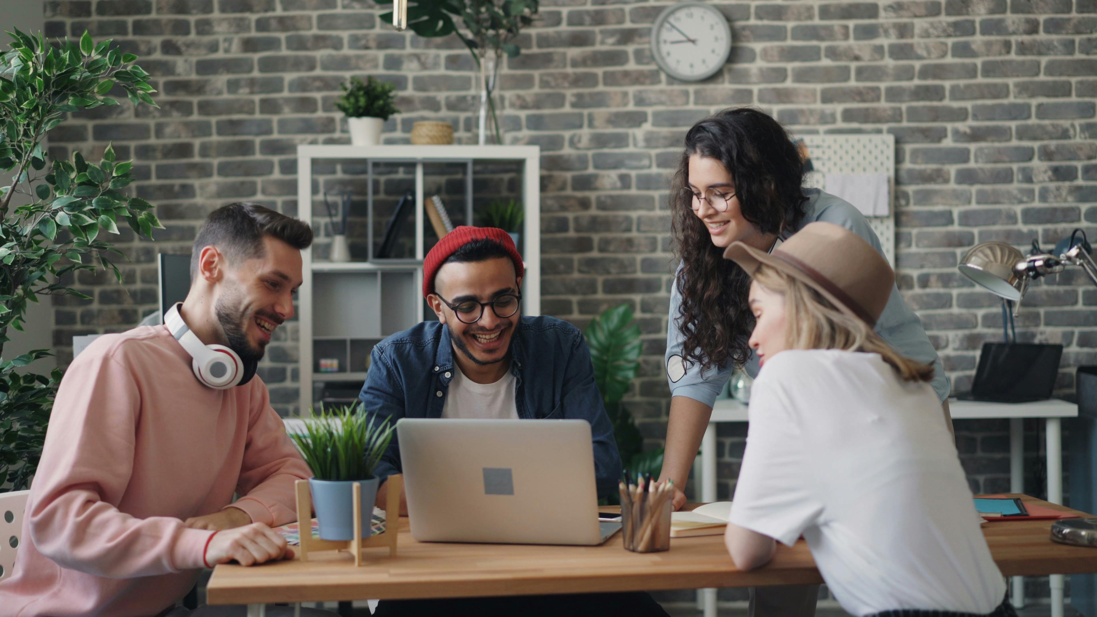 group sitting around laptop