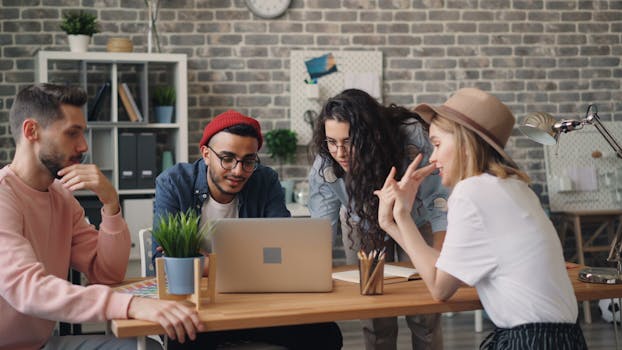 Diverse group of coworkers collaborating on a project in a stylish modern office.