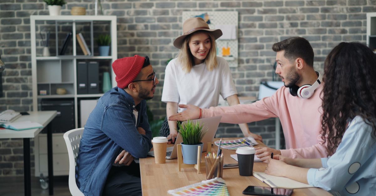 Group of young professionals brainstorming ideas in a modern office environment.