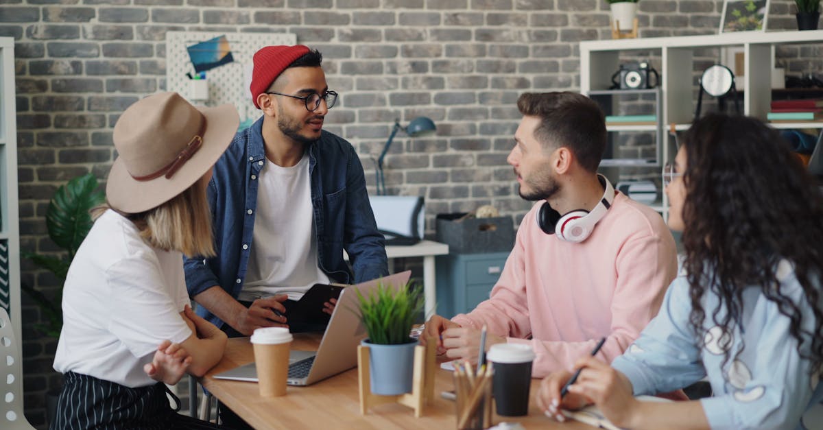 Young creative team discussing project ideas in a modern office setting.