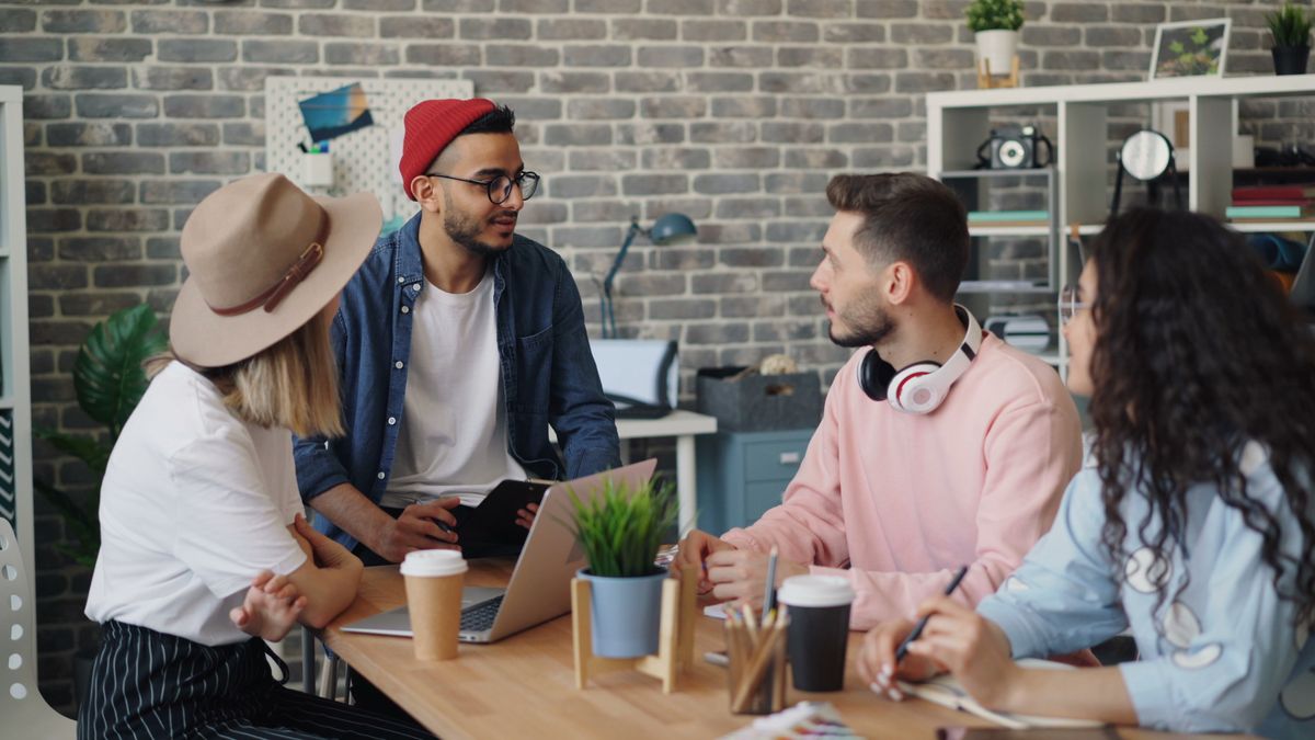 Small team reviewing work together around a laptop, photo by Vitaly Gariev on Pexels