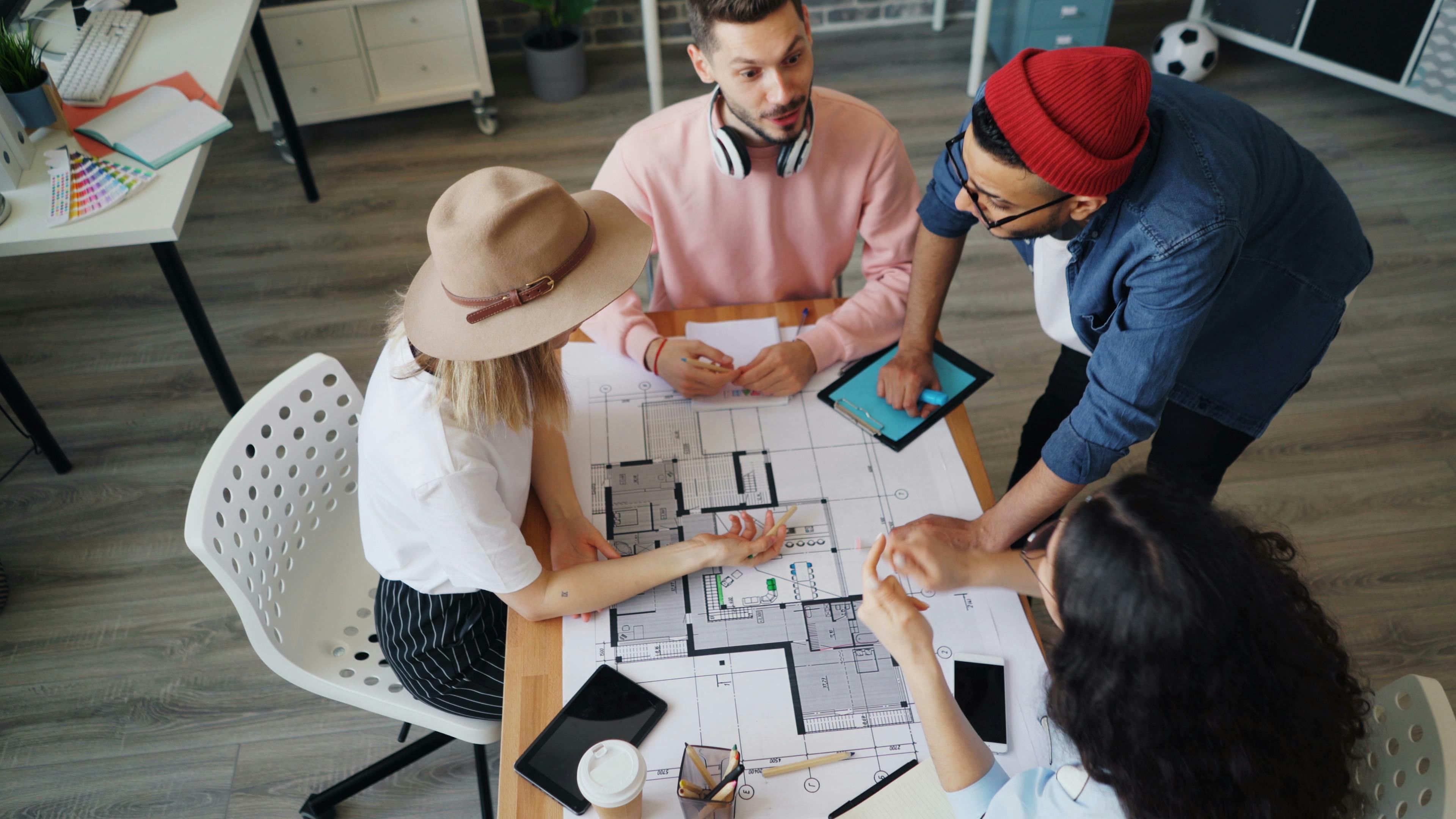 A group of people at a table with a laptop