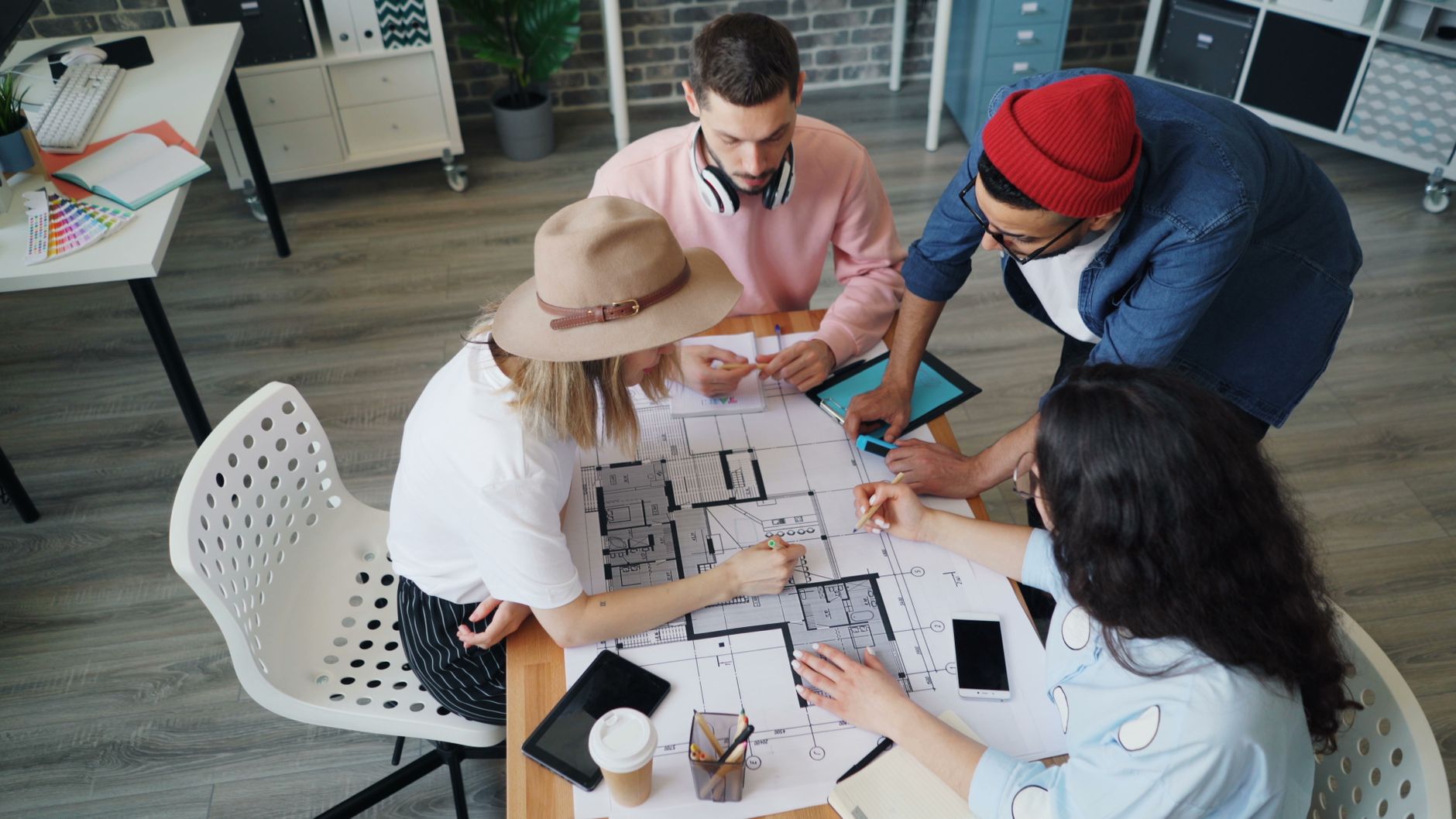 Professionals discussing plans around a table