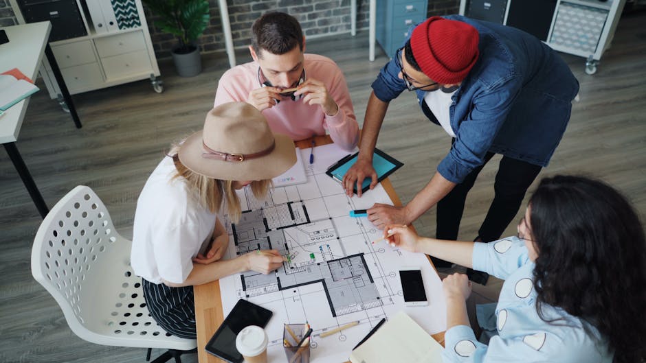 Group of diverse individuals collaborating on a project in a modern office setting.