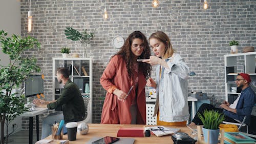 Two women in an office looking at a computer screen