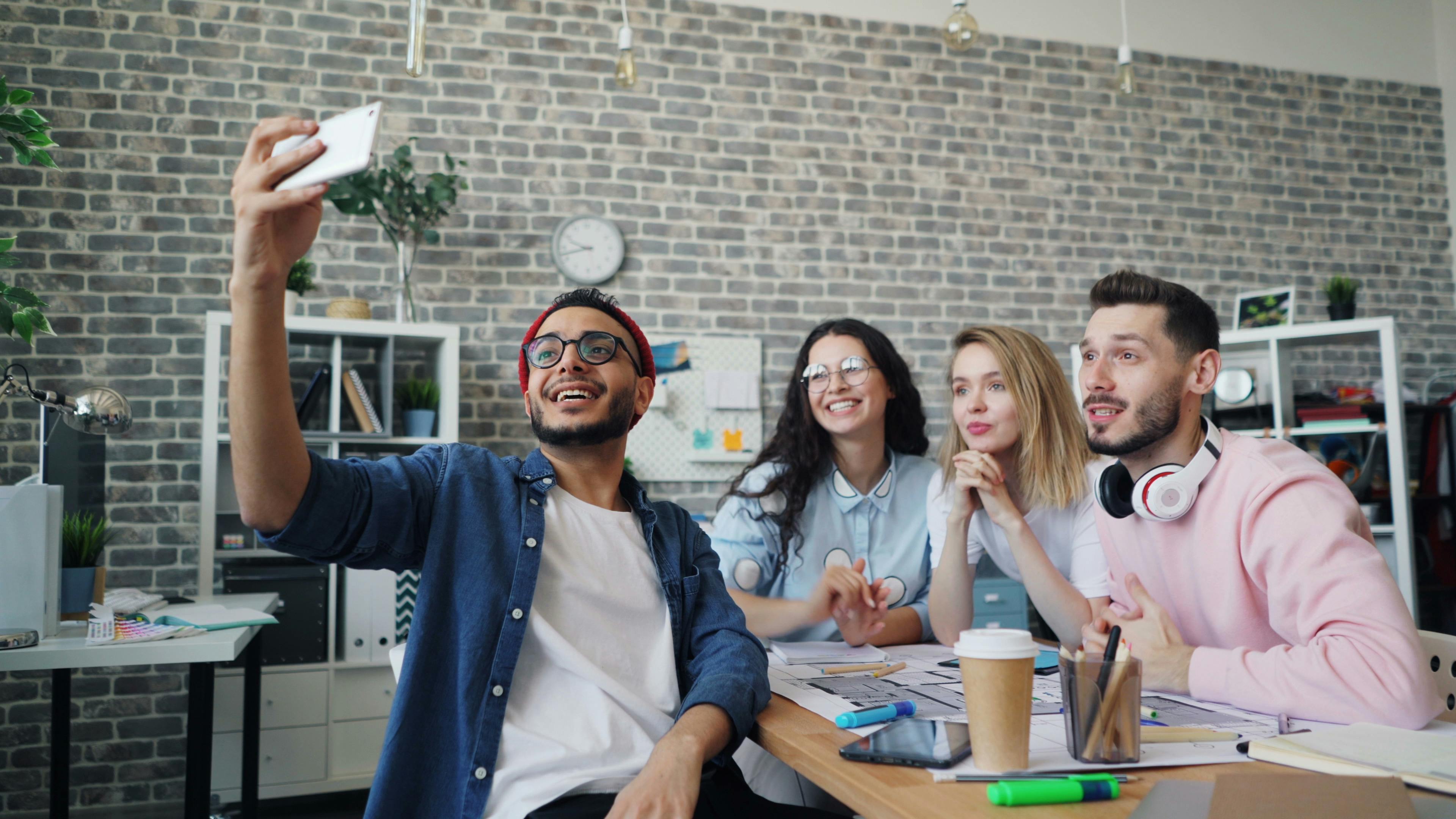 group of people taking a selfie in a meeting room