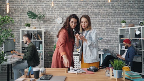 Two women standing in an office with a laptop