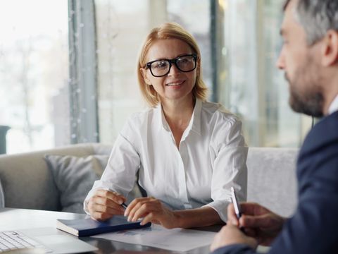 Two colleagues discussing strategy in a modern office