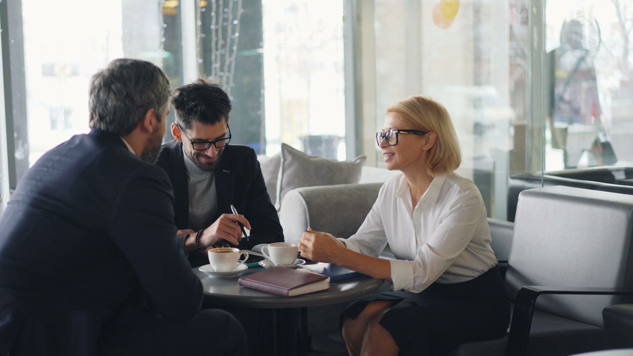 Professionals in a business meeting at a café