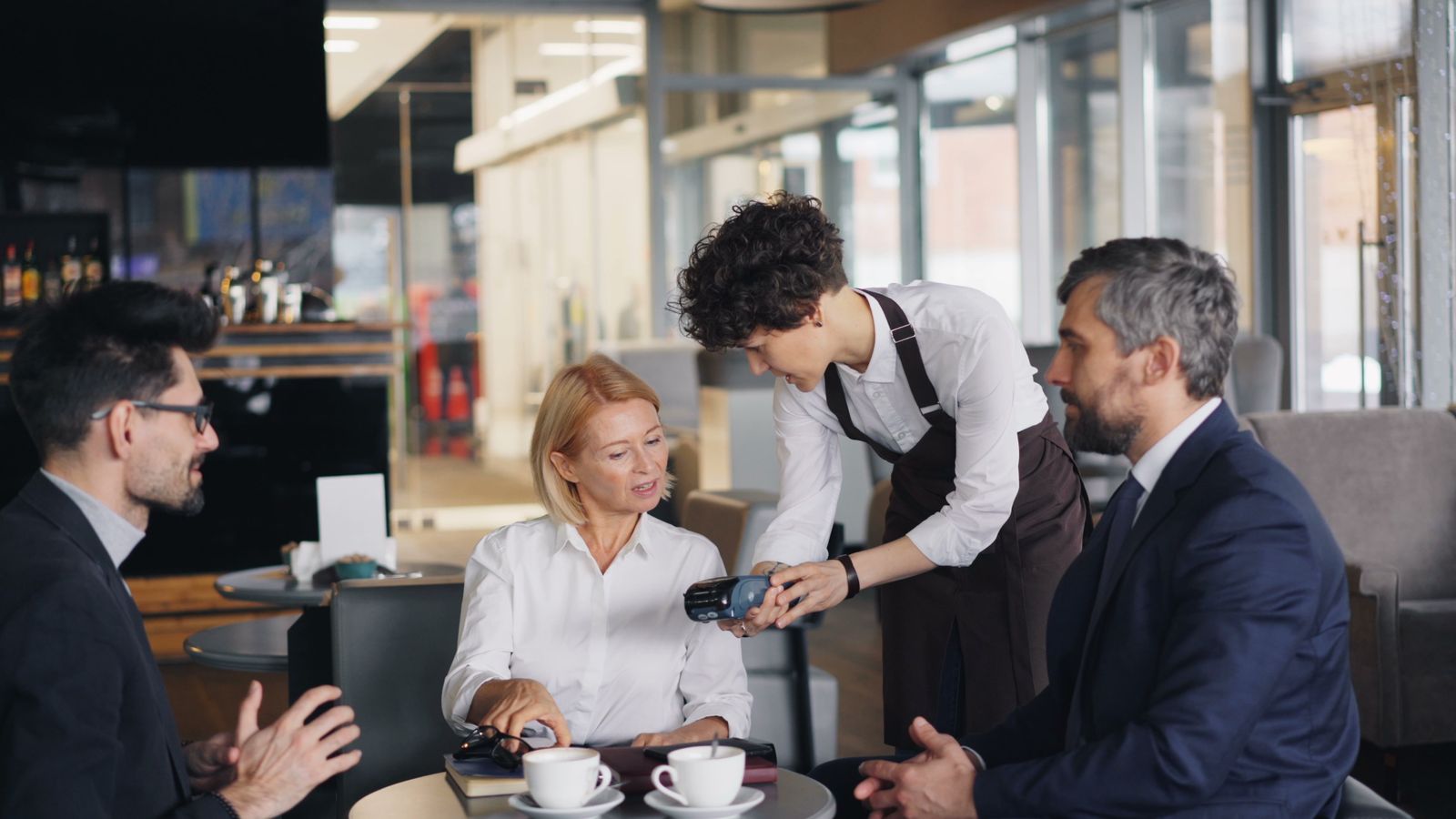 People checking a payment during a meeting in a cafe