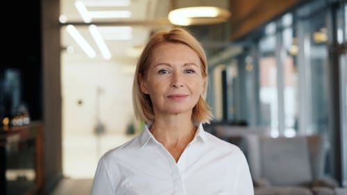 A woman in a white shirt standing in an office