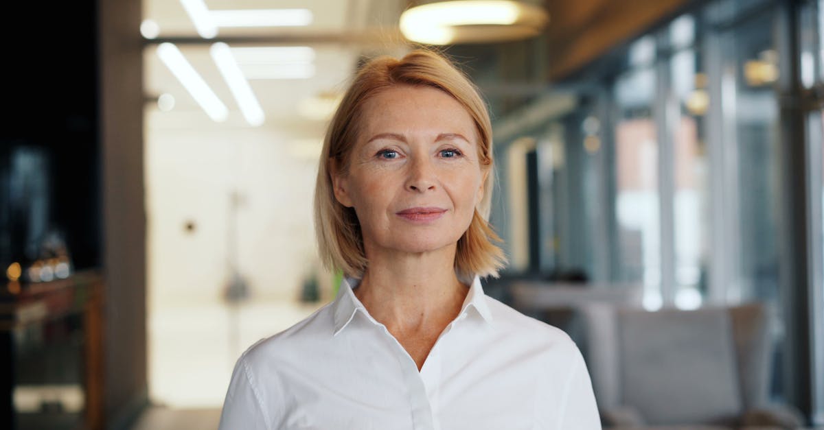 A woman in a white shirt standing in an office