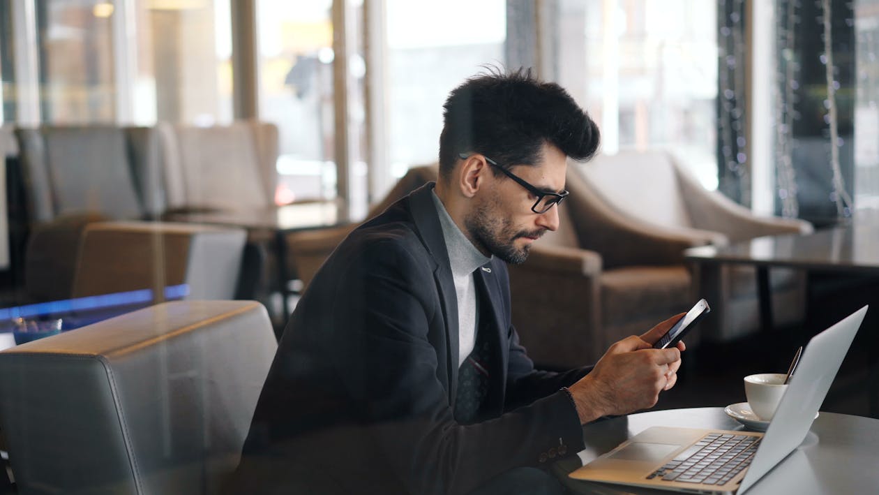 A man in a suit using a cell phone