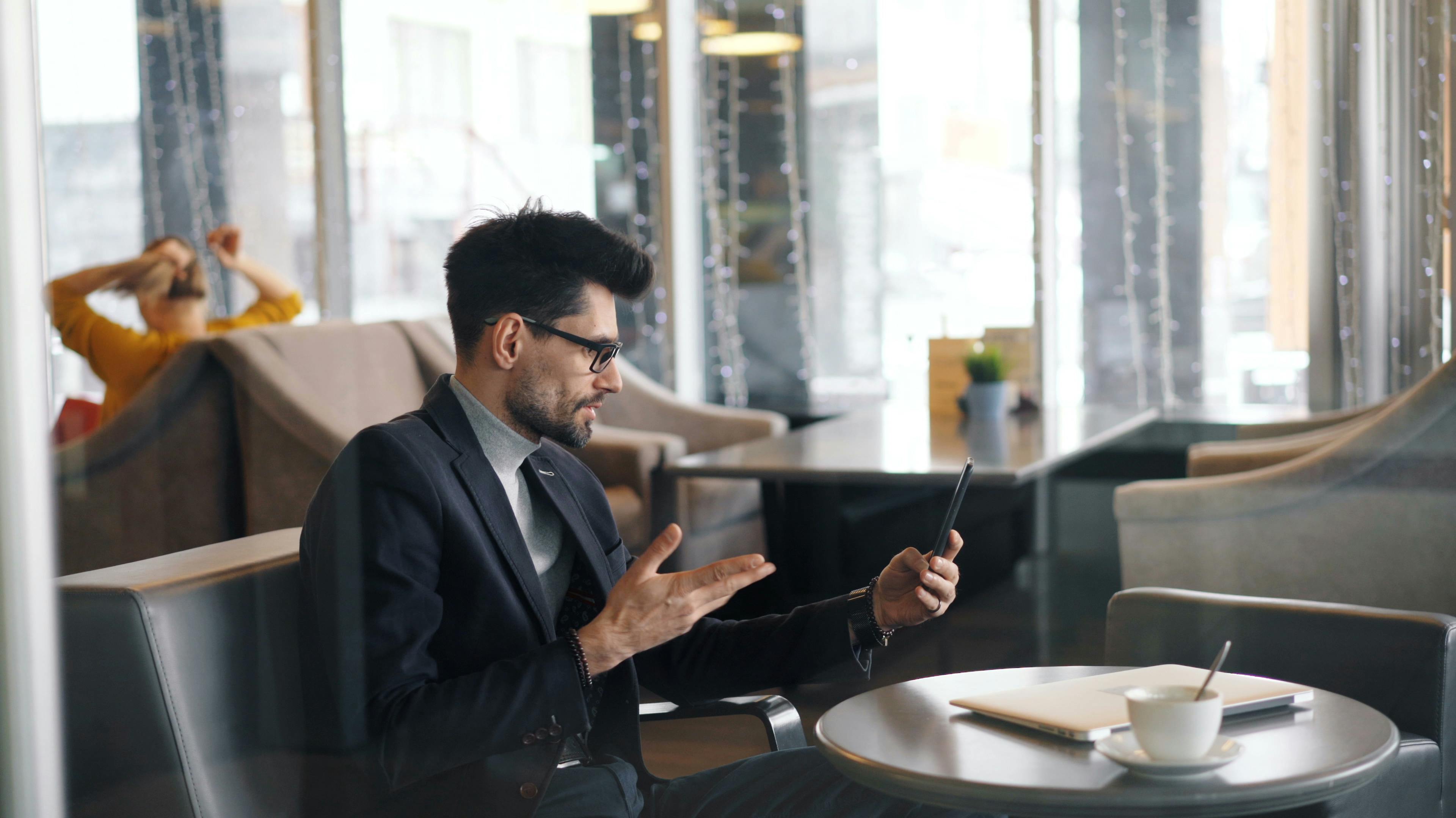 Businessman making a video call in a stylish cafe