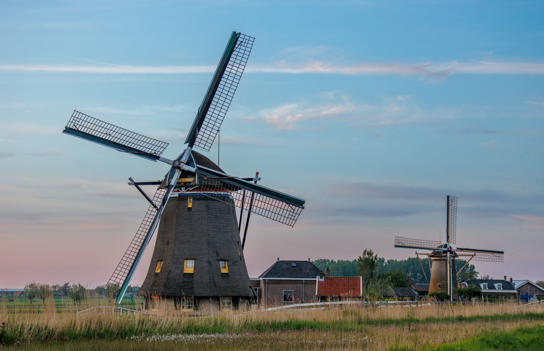 Beautiful windmills in Maasland, Netherlands at sunset, capturing scenic rural charm.
