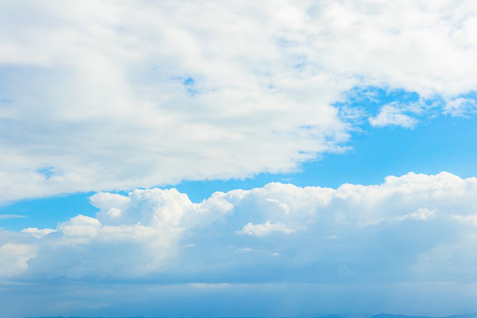 Serene view of blue sky and fluffy white clouds, perfect for nature themes.