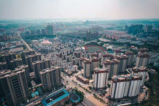 Drone shot showcasing the urban landscape of Jiujiang, Jiangxi, China from above.