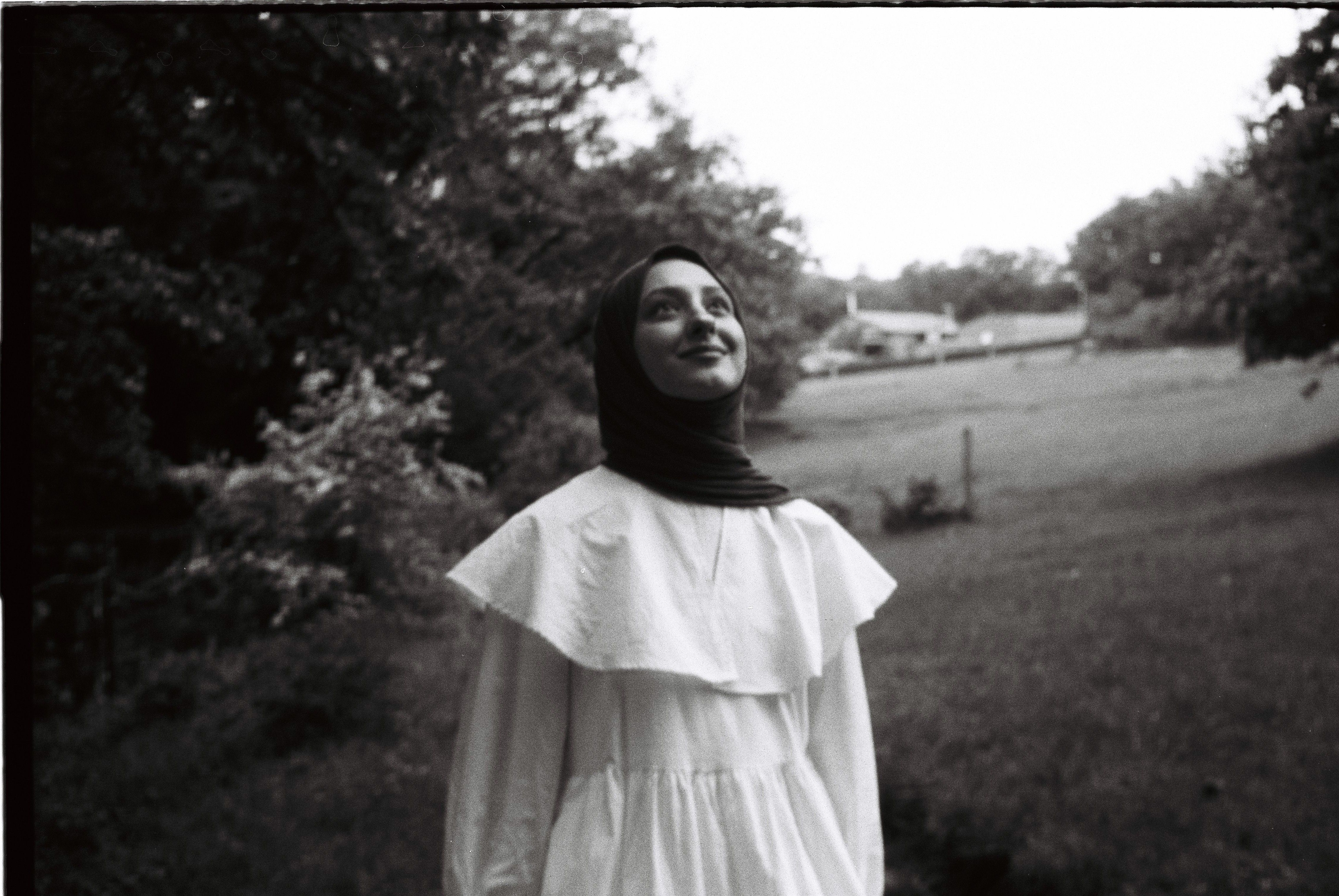 Black and White Film Photo of a Young Woman in a Dress and Headscarf ...