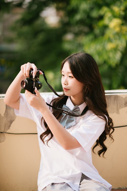 Portrait of Woman Taking Pictures with Camera