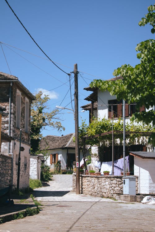 A narrow street with houses and trees