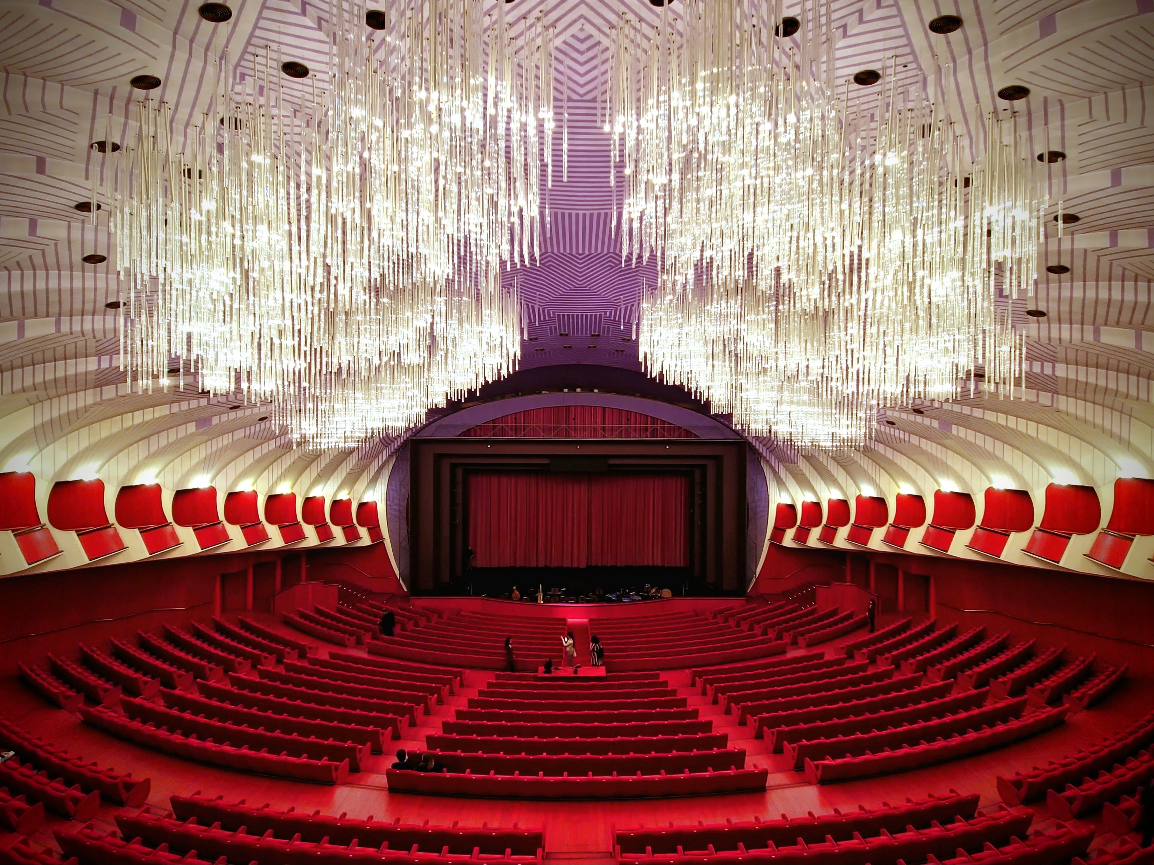The interior of a large auditorium with red seats · Free Stock Photo