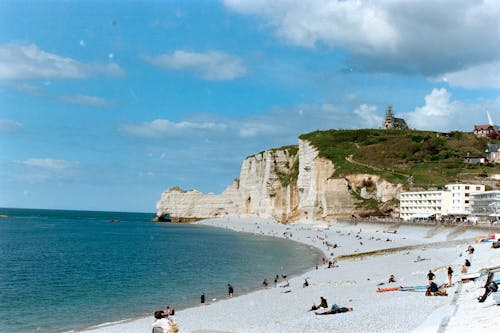 A beach with people on it and a cliff