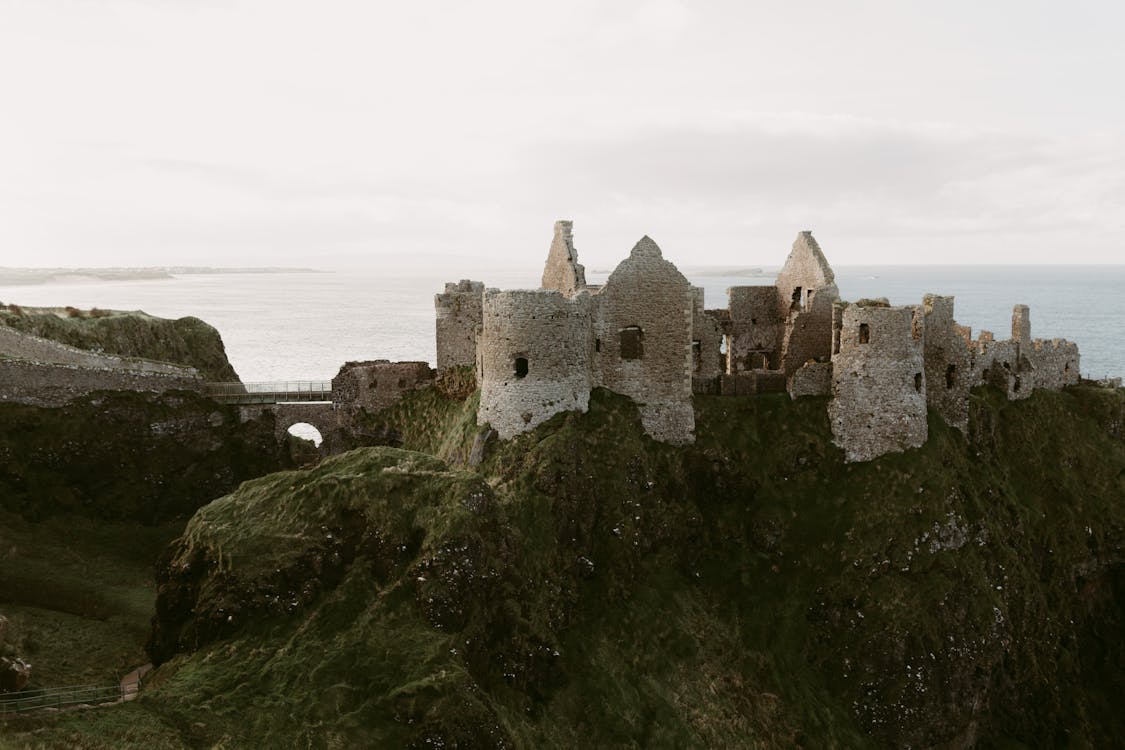 Free old medieval ruins of Dunluce Castle on ocean coast in northern Ireland famous place in uk Stock Photo