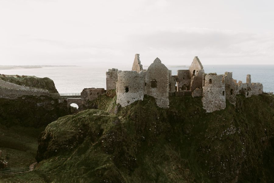 The ruins of Dunluce Castle on a clifftop above the sea