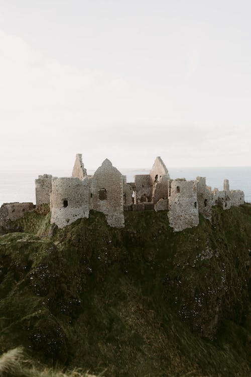 Free old medieval ruins of Dunluce Castle on ocean coast in northern Ireland famous place in UK Stock Photo