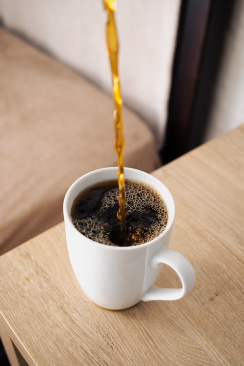 Free Pouring Tea Into a Cup Stock Photo