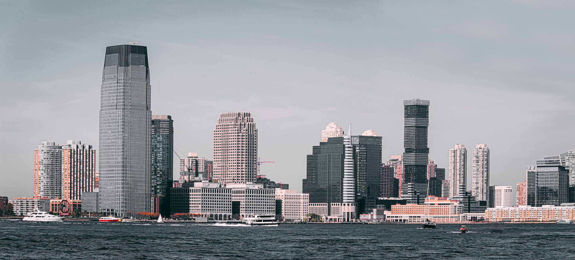 A breathtaking view of Jersey City's skyline from across the Hudson River with modern skyscrapers and waterfront buildings.