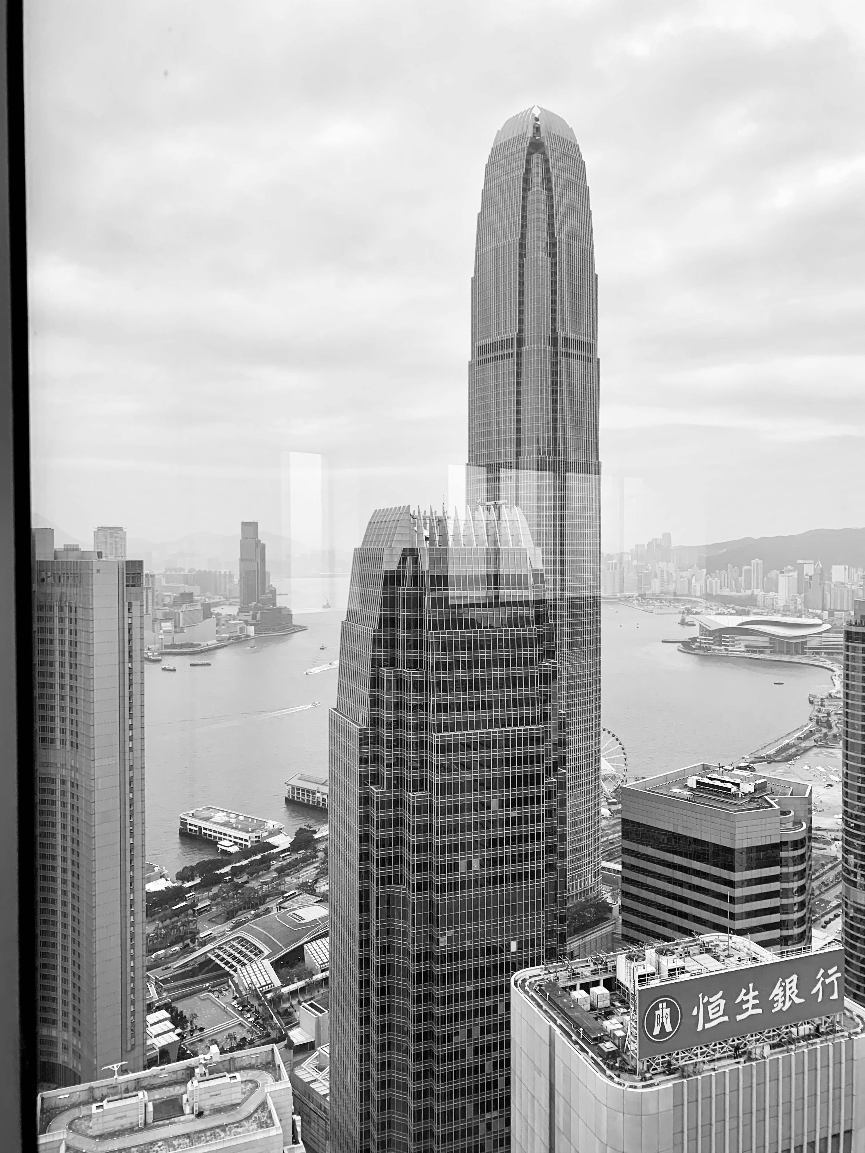 香港迷人的黑白城市景观，以标志性的国际金融中心大厦和维多利亚港为特色