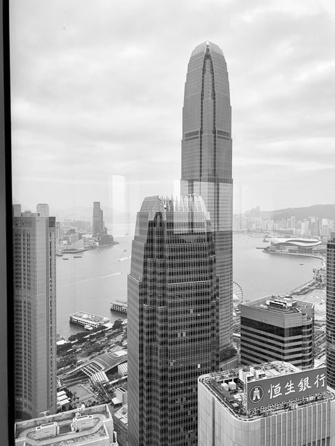 Captivating black and white cityscape of Hong Kong with the iconic IFC Tower and Victoria Harbour.