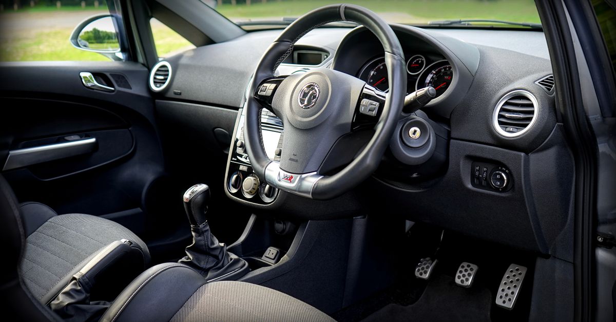 Detailed view of a modern car's interior featuring the steering wheel and dashboard.