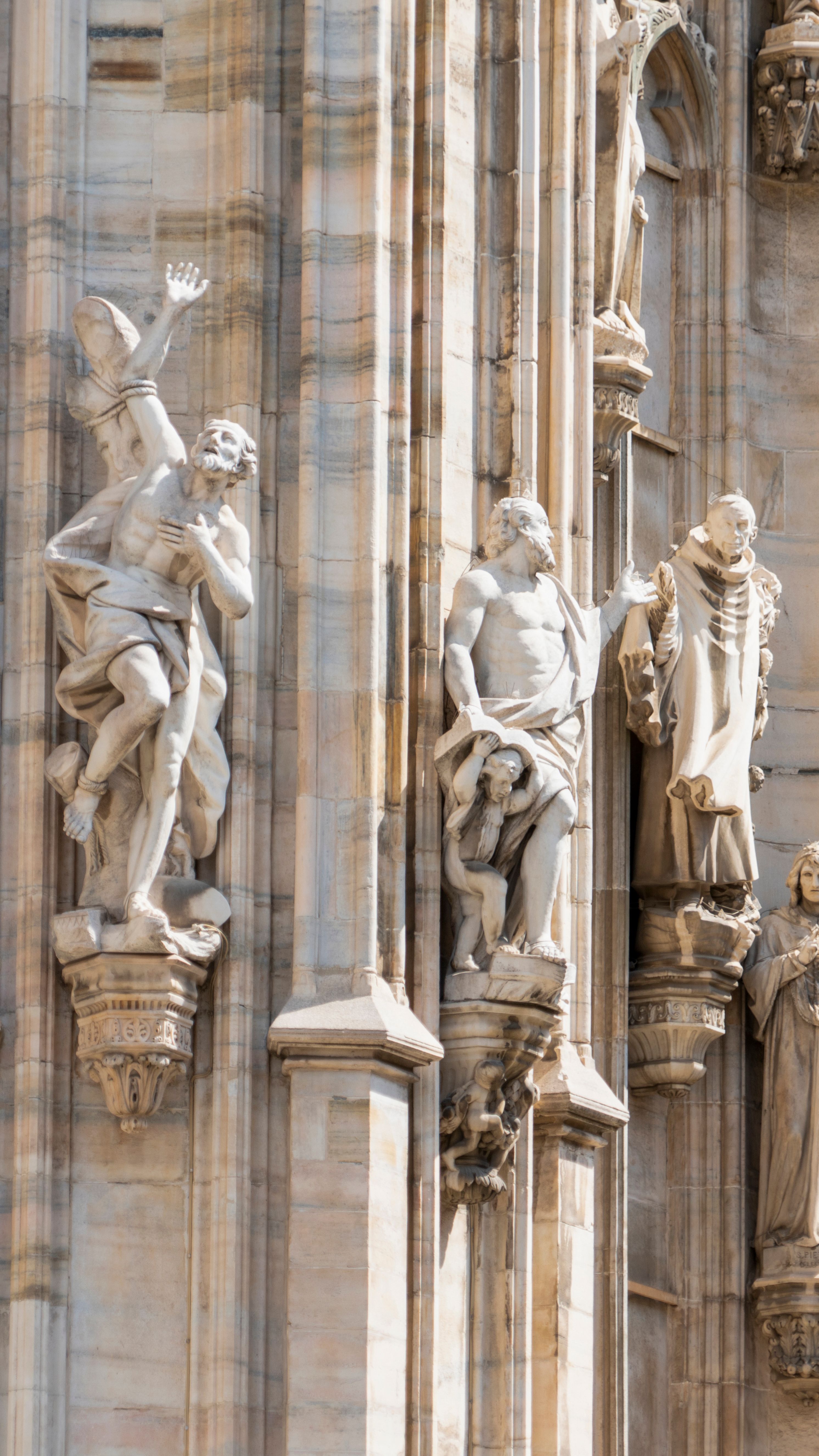 Detail of gothic statues adorning a cathedral, capturing religious artistry.