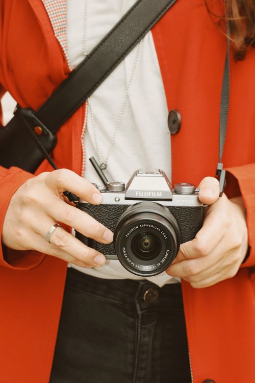 Free Close-up of a person holding a camera in Berlin, showcasing photography passion. Stock Photo