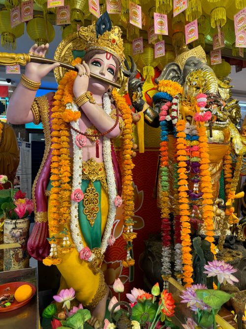 Free Vibrant statues of Hindu deities adorned with marigold garlands in a temple setting. Stock Photo