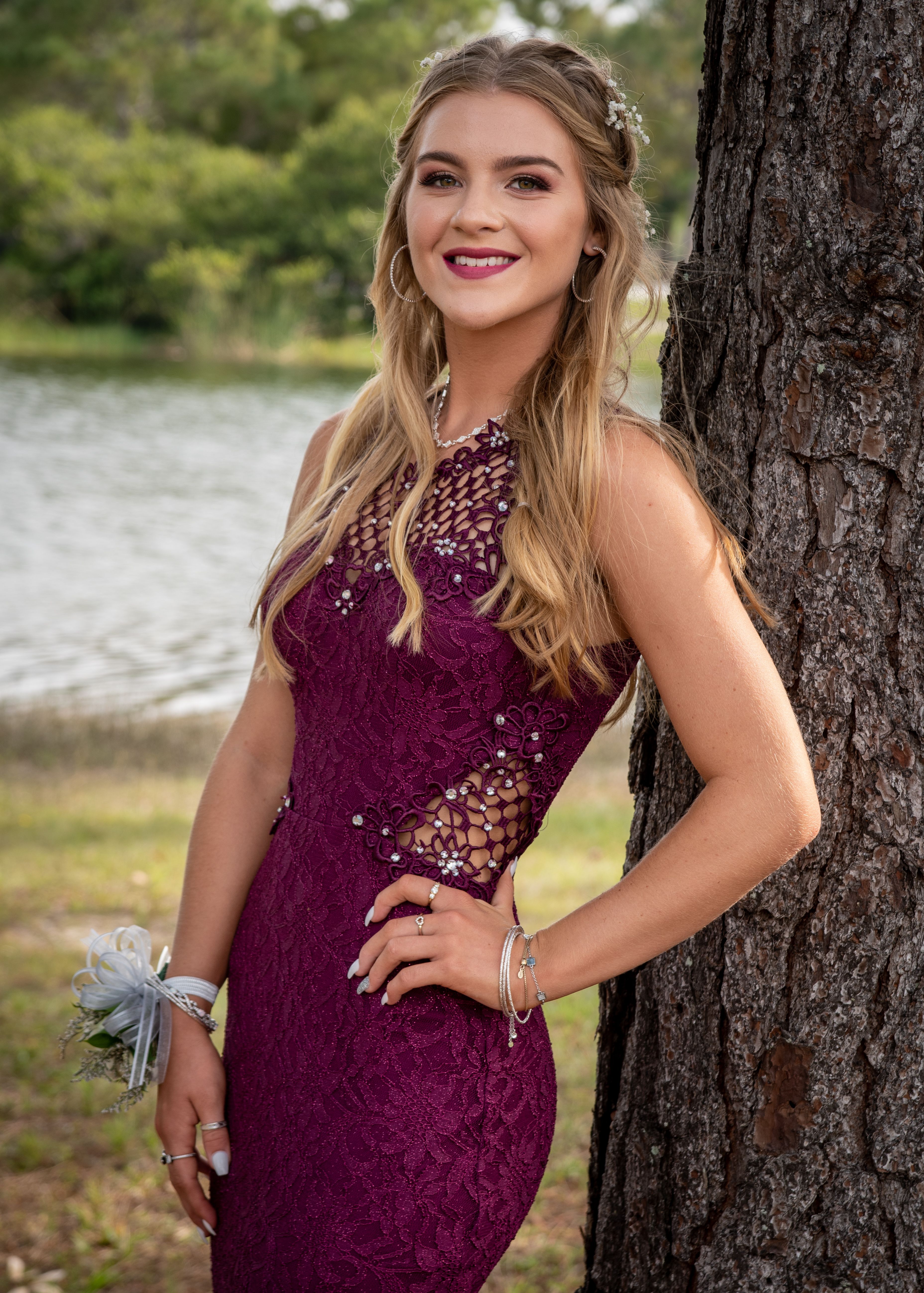 Elegant Young Woman in a Purple Dress Posing under a Tree · Free Stock ...